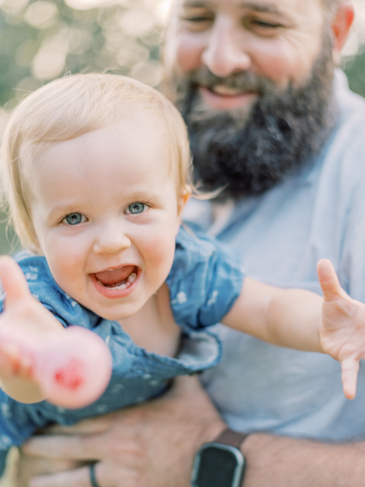Dad swinging daughter like an airplane during Richmond family session.