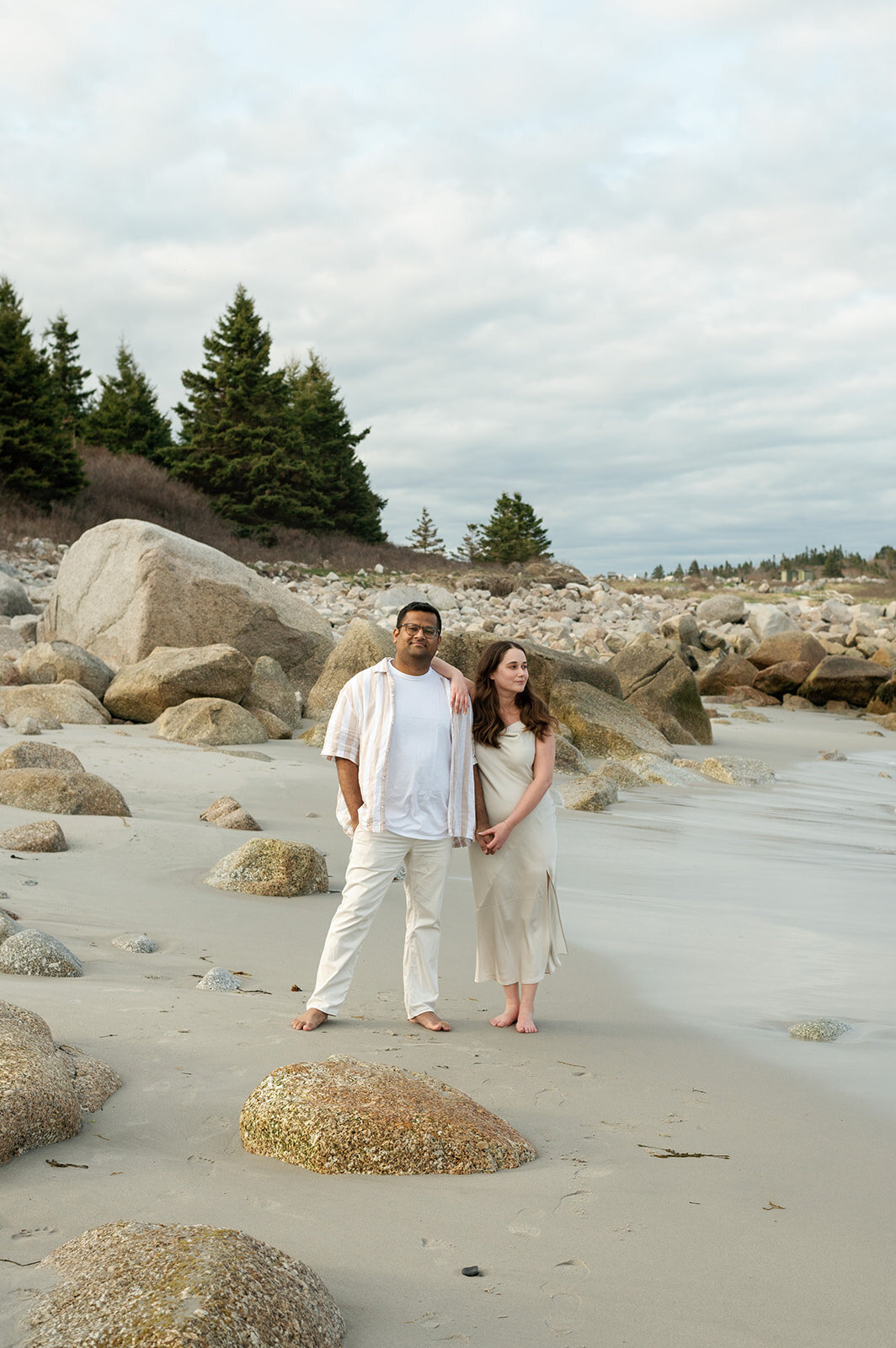 Couple pose for engagement session at Crystal Crescent Beach