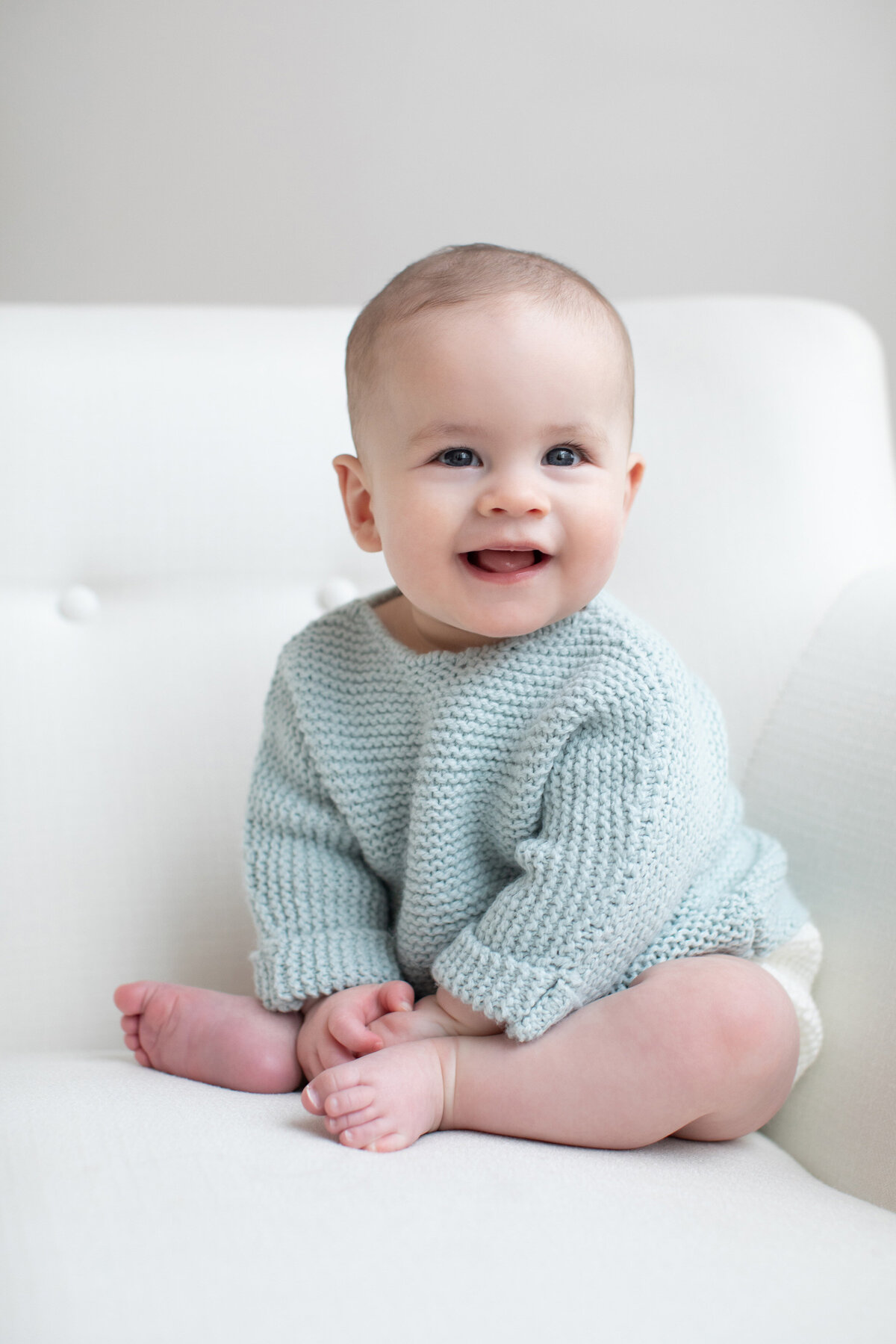 baby-smiling-on-couch