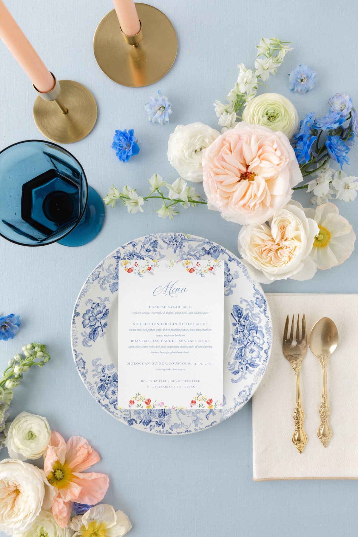 watercolor floral menu on a blue china plate with flowers