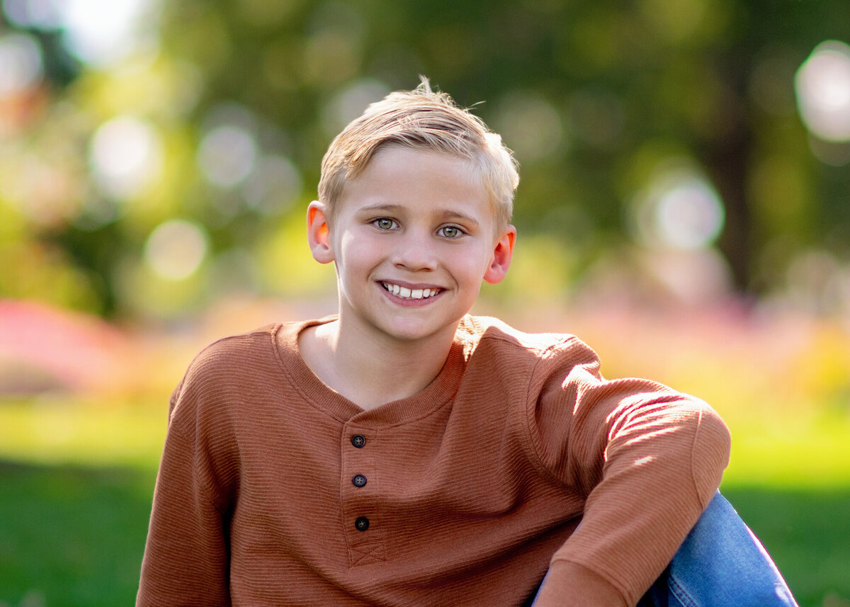 Closeup of a boy in an orange shirt