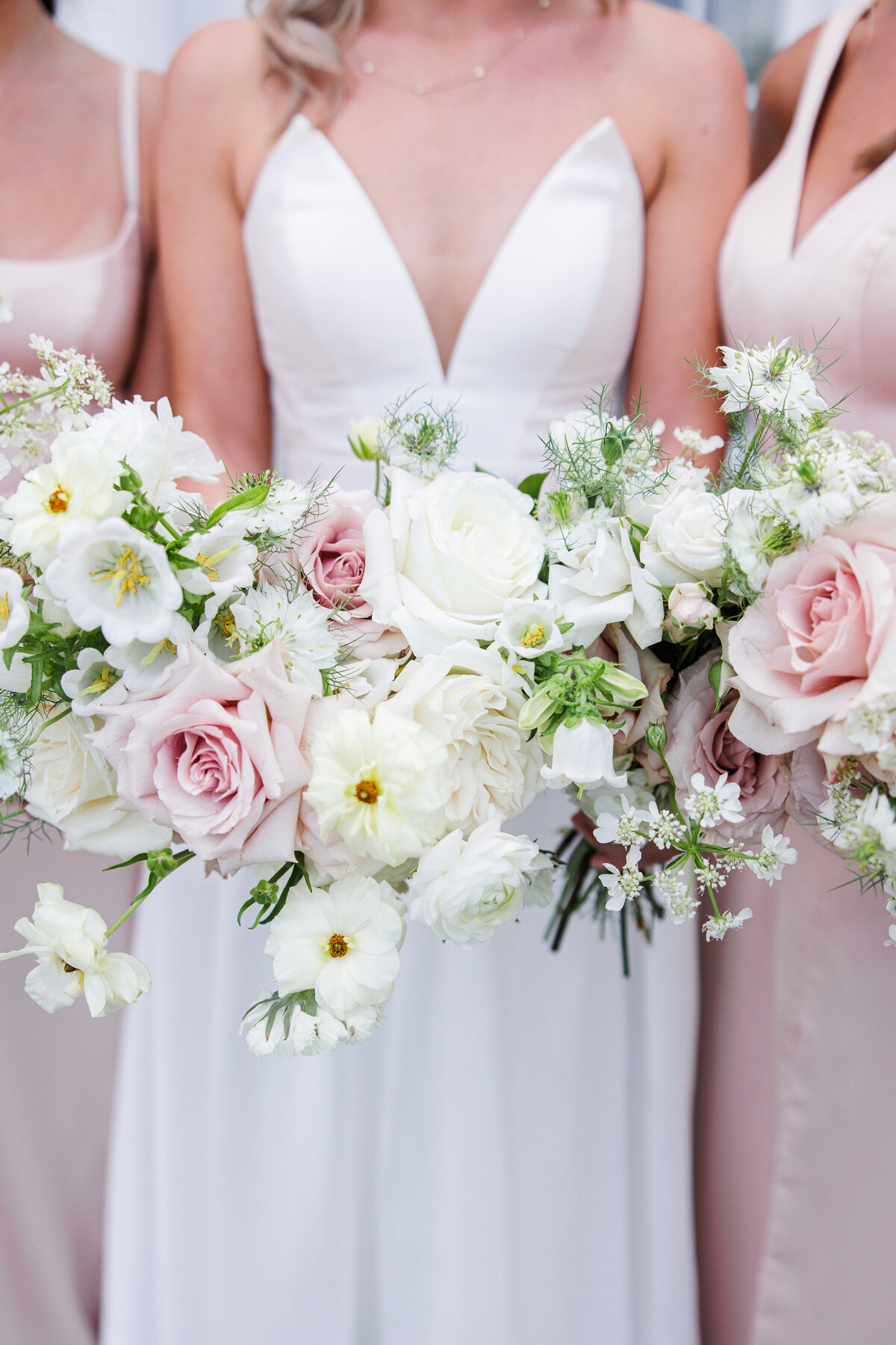 Close up of bride and bridesmaids holding their bouquets during a Tupper Manor wedding