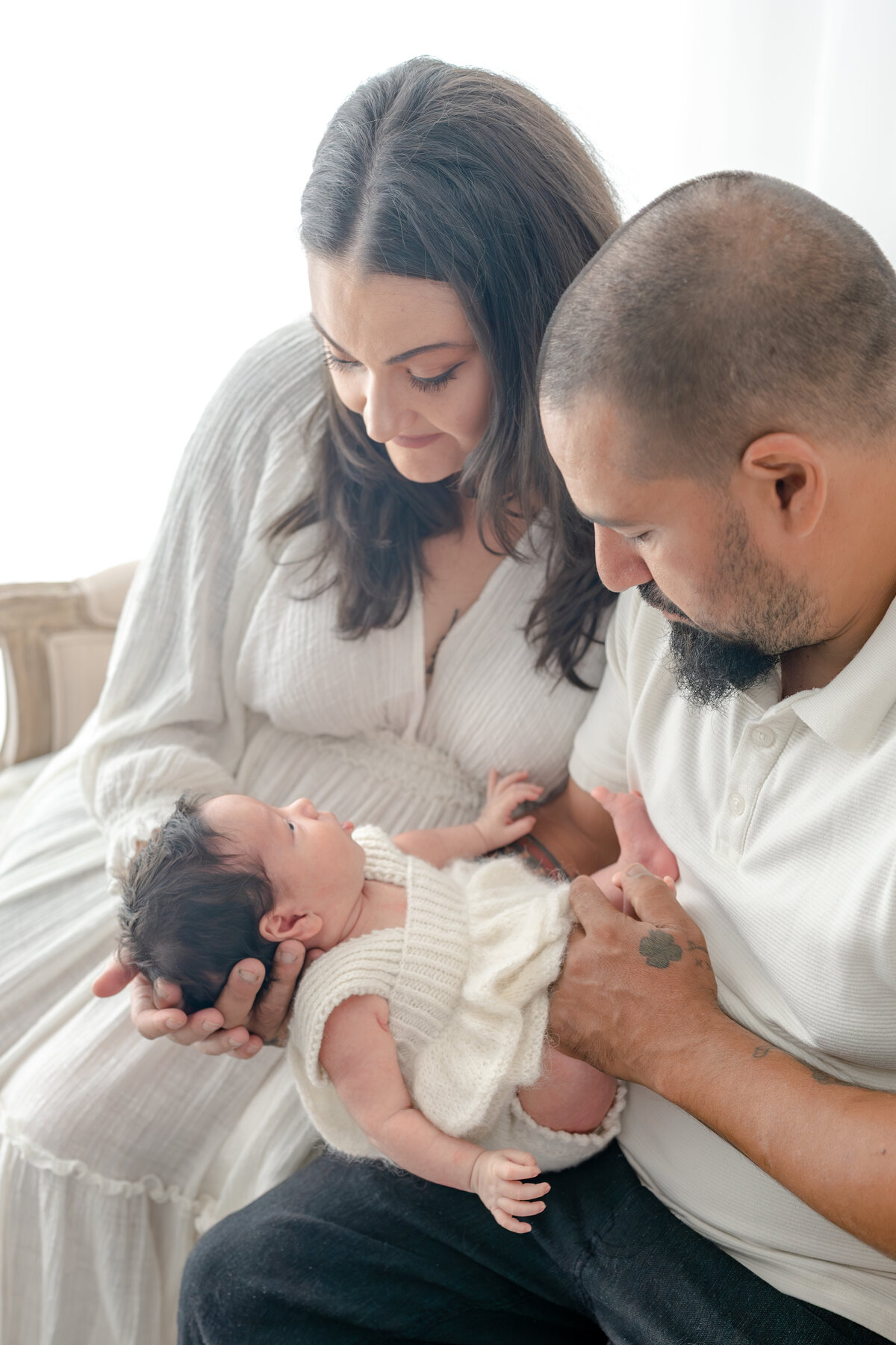 Family holding baby during natural light Barrie newborn photography session 