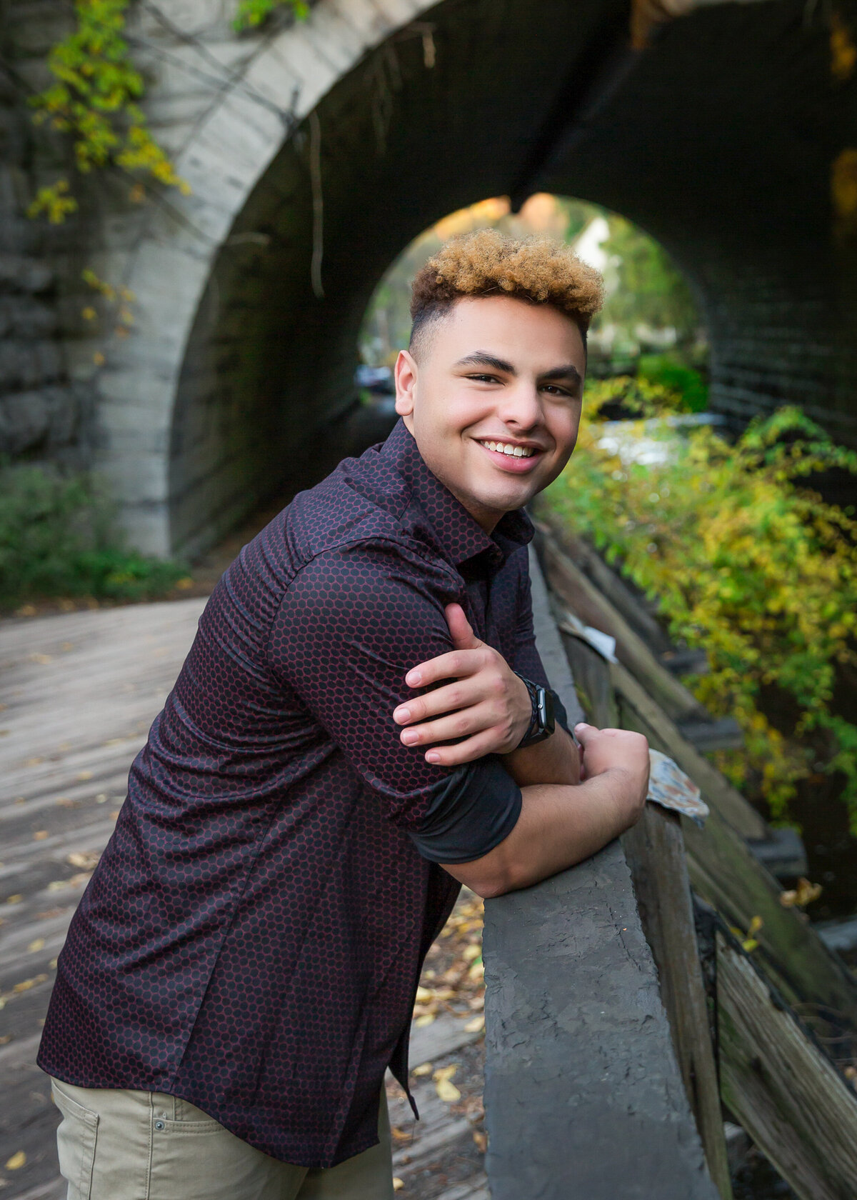 Boy from Brighton, NY taking senior pictures with a natural smile outdoors