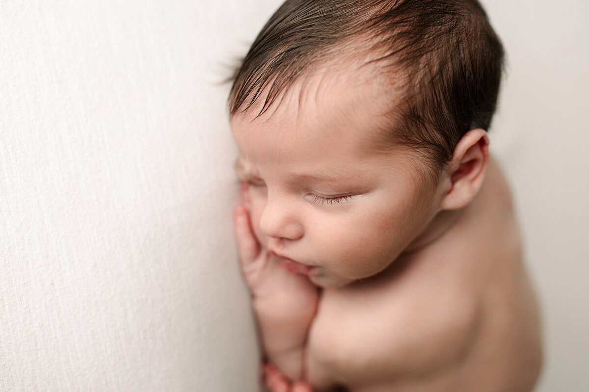Newborn side profile details and dark hair