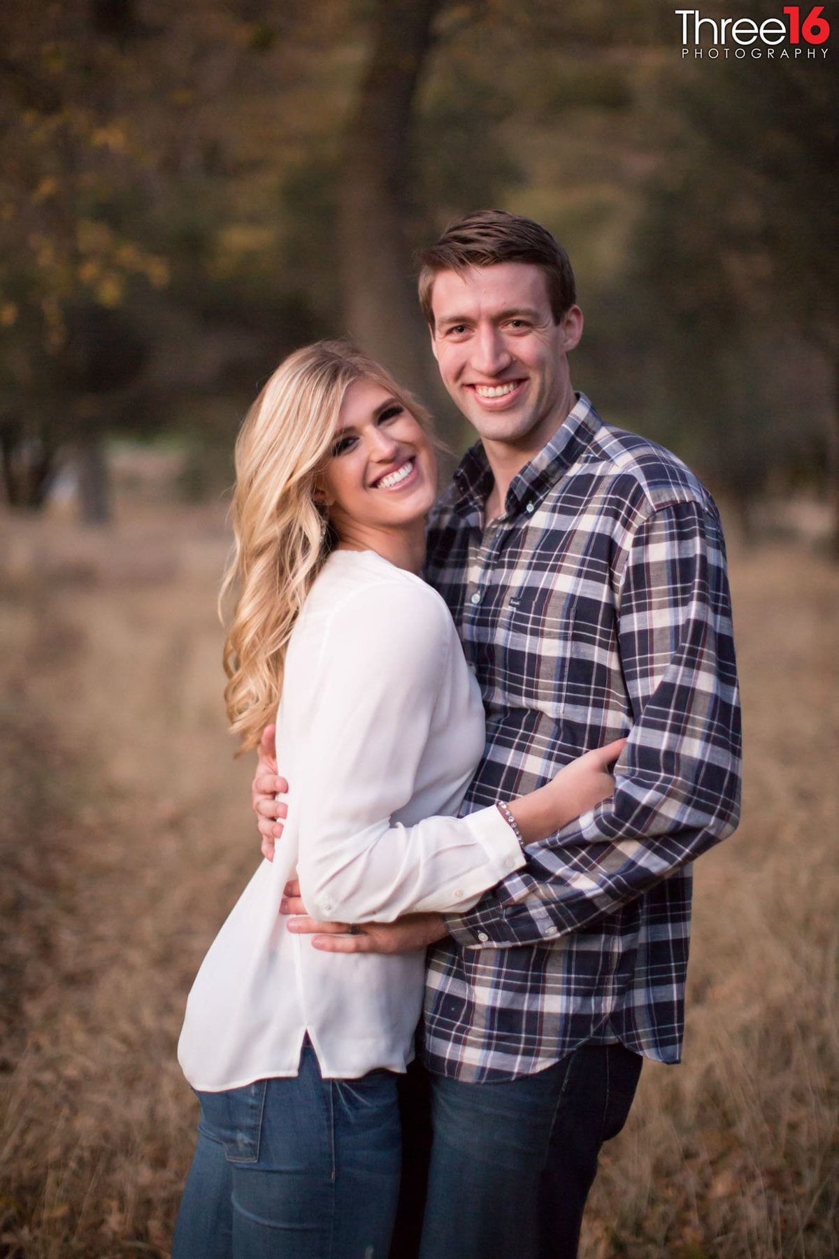 Engaged couple are all smiles during engagement photo session
