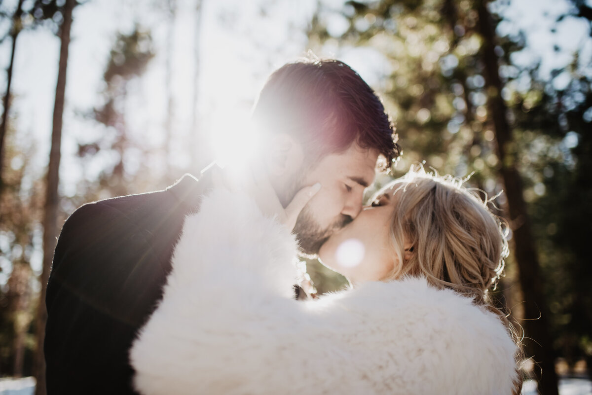 Jackson Hole Photographers capture bride and groom kissing during golden hour portraits