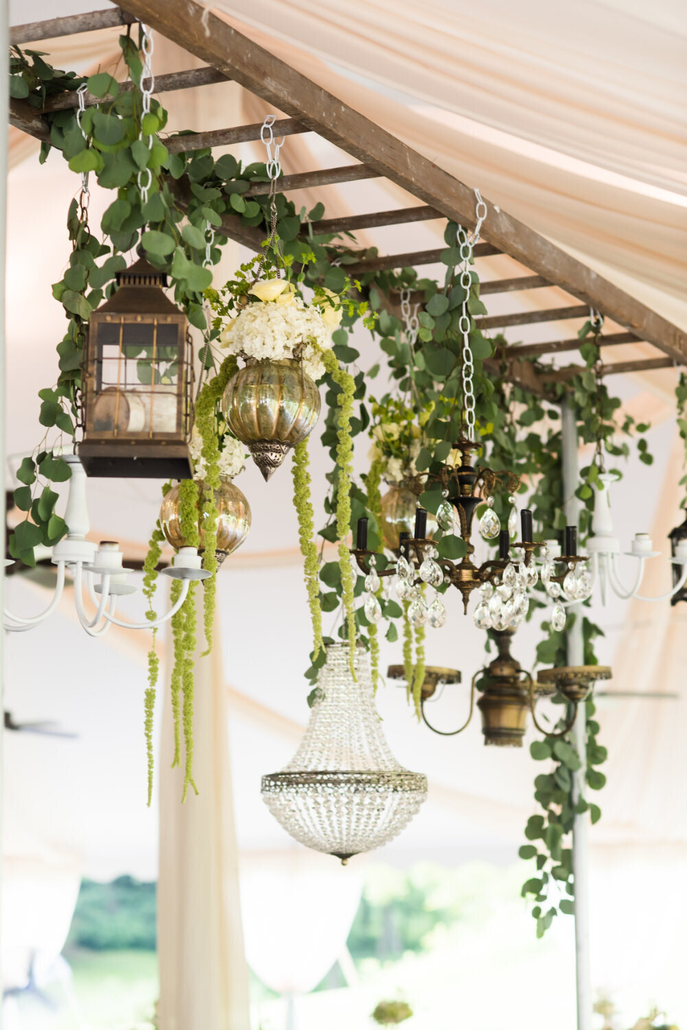 wedding decor with chandeliers greenery and ladders for unique reception tented wedding