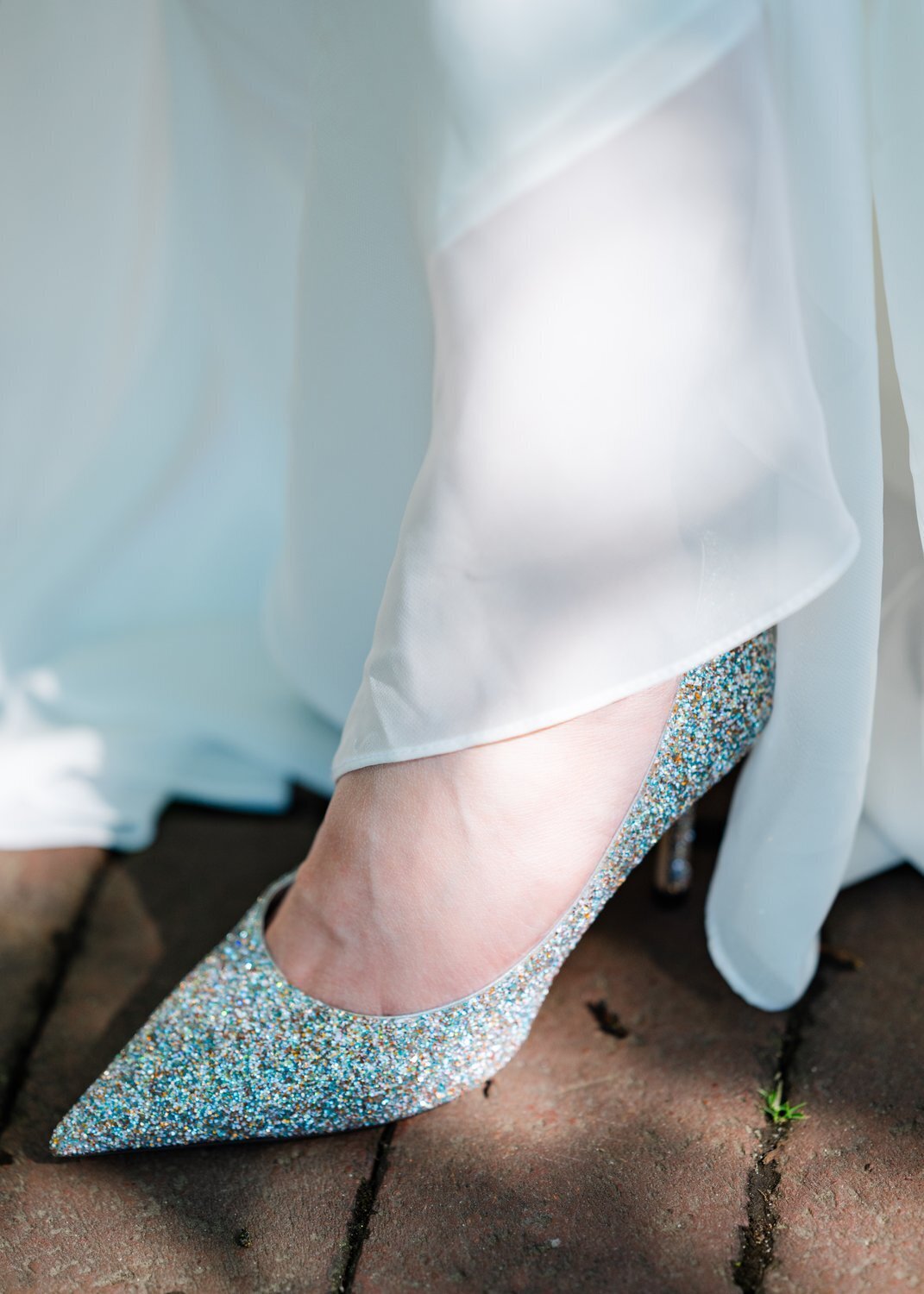 details of wedding shoes on bride