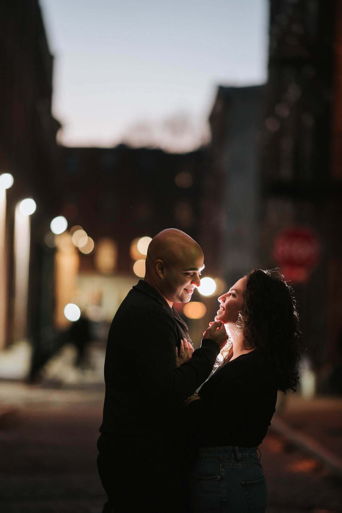 Soon to be husband and wife backlit in old city philadelphia