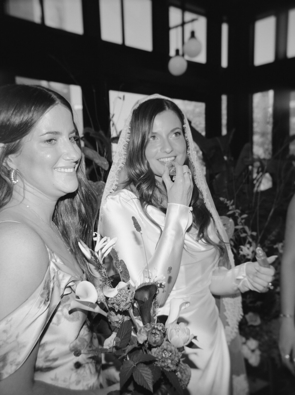 Candid film wedding photographer in Detroit Christina Harrison captures bride putting on lip gloss at Shinola Hotel wedding