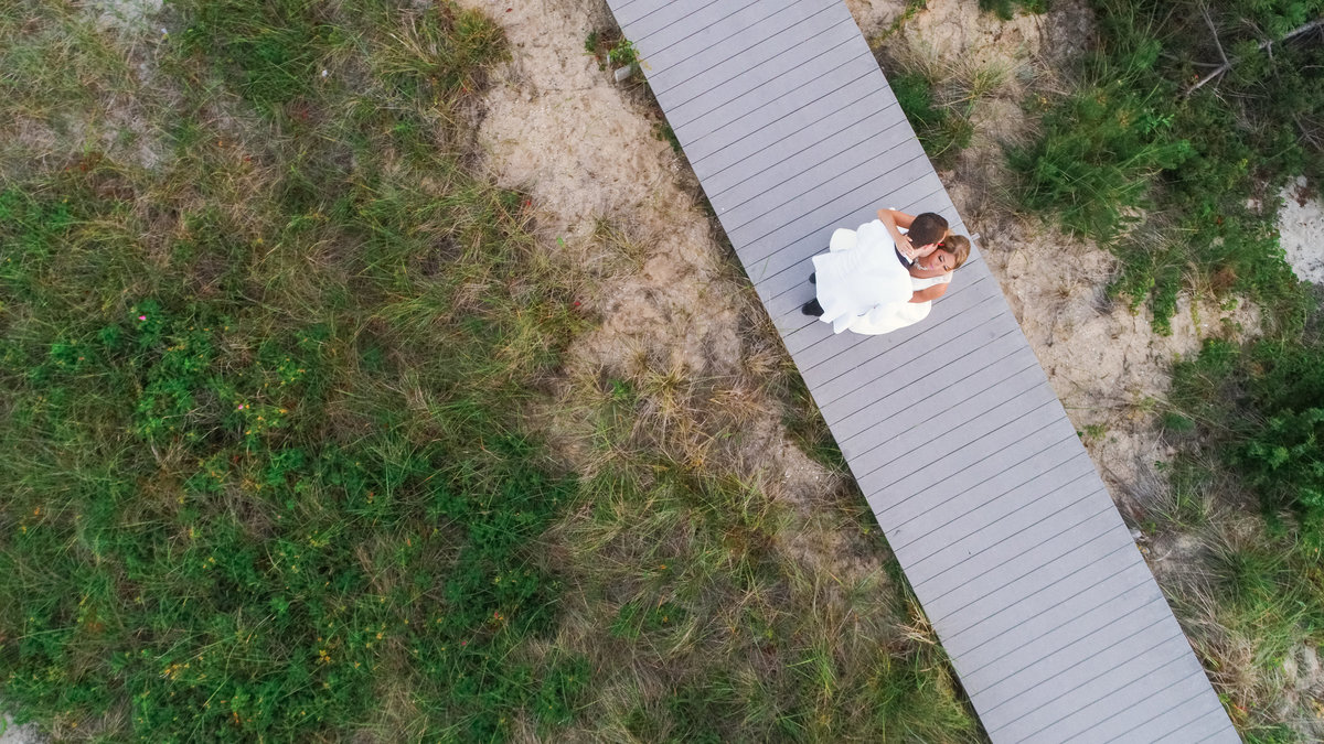 Drone photo of bride and groom on the boardwalk