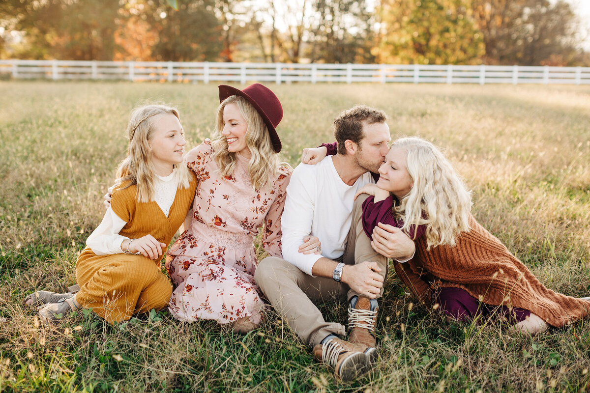 Natural light family photography, parents and daughters in field, Nicola Herring Photographer