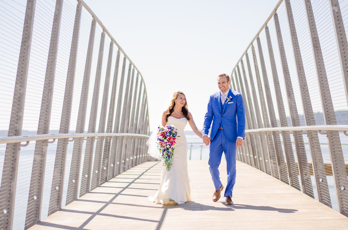 Couple holding hands on bridge