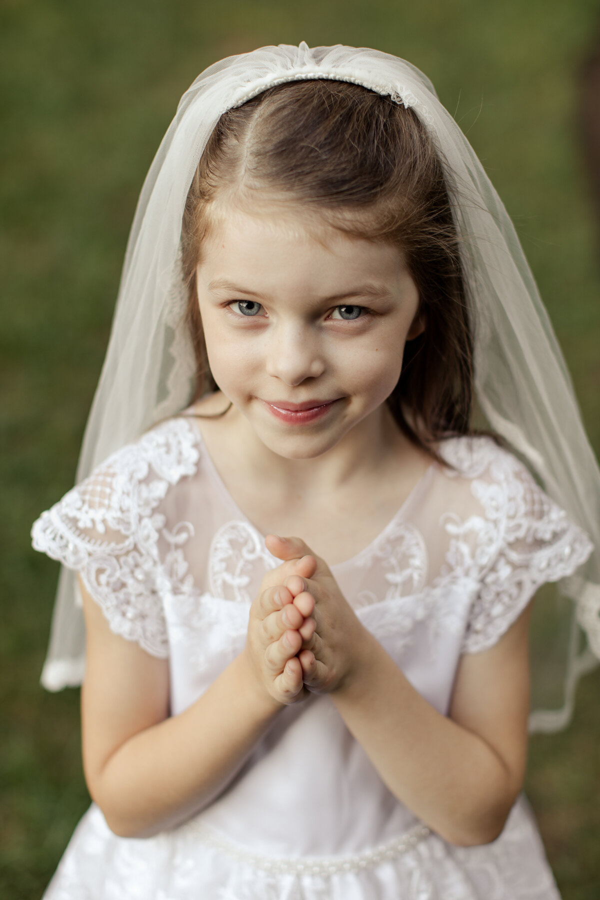 little girl smiling with praying hands