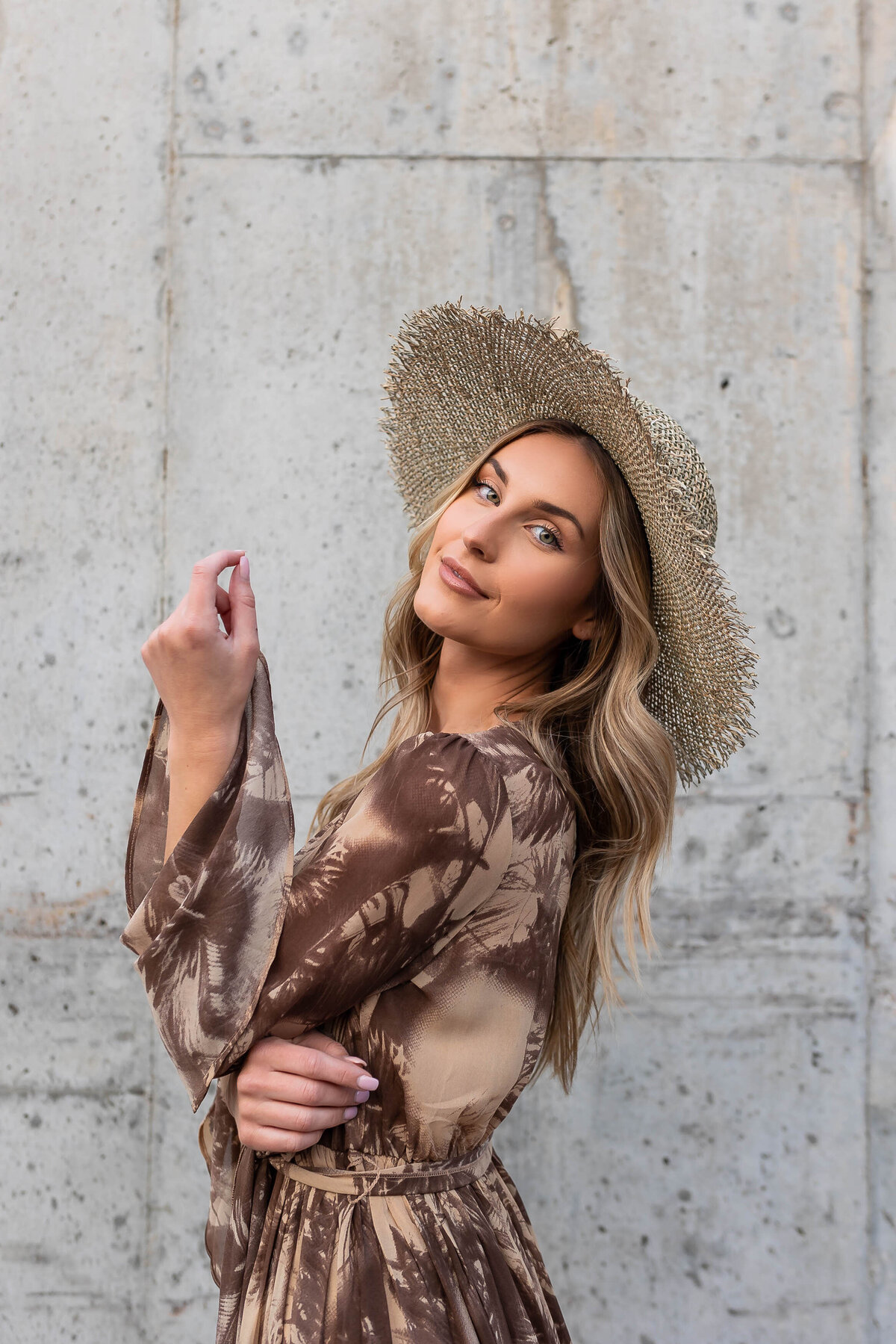 A person with a large hat on slightly leaning back