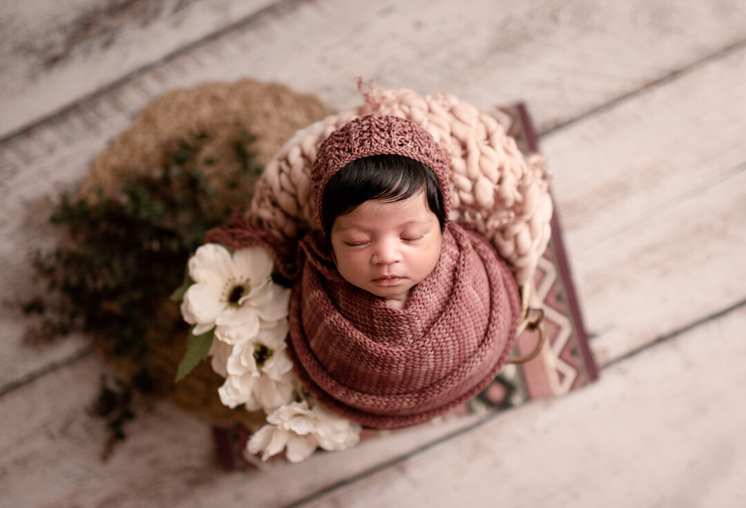 Newborn Baby posed with flowers By For The Love of Photography