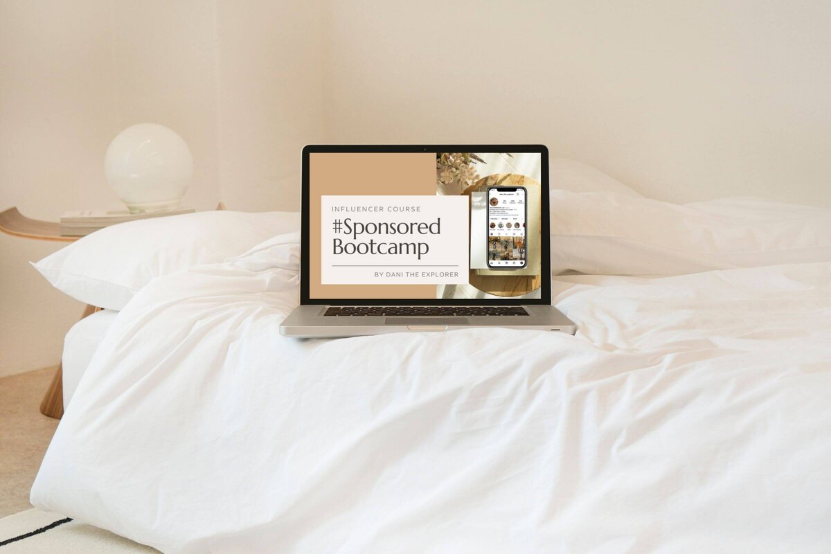 Picture of an influencer's laptop on her bed while she is taking the best instagram influencer course