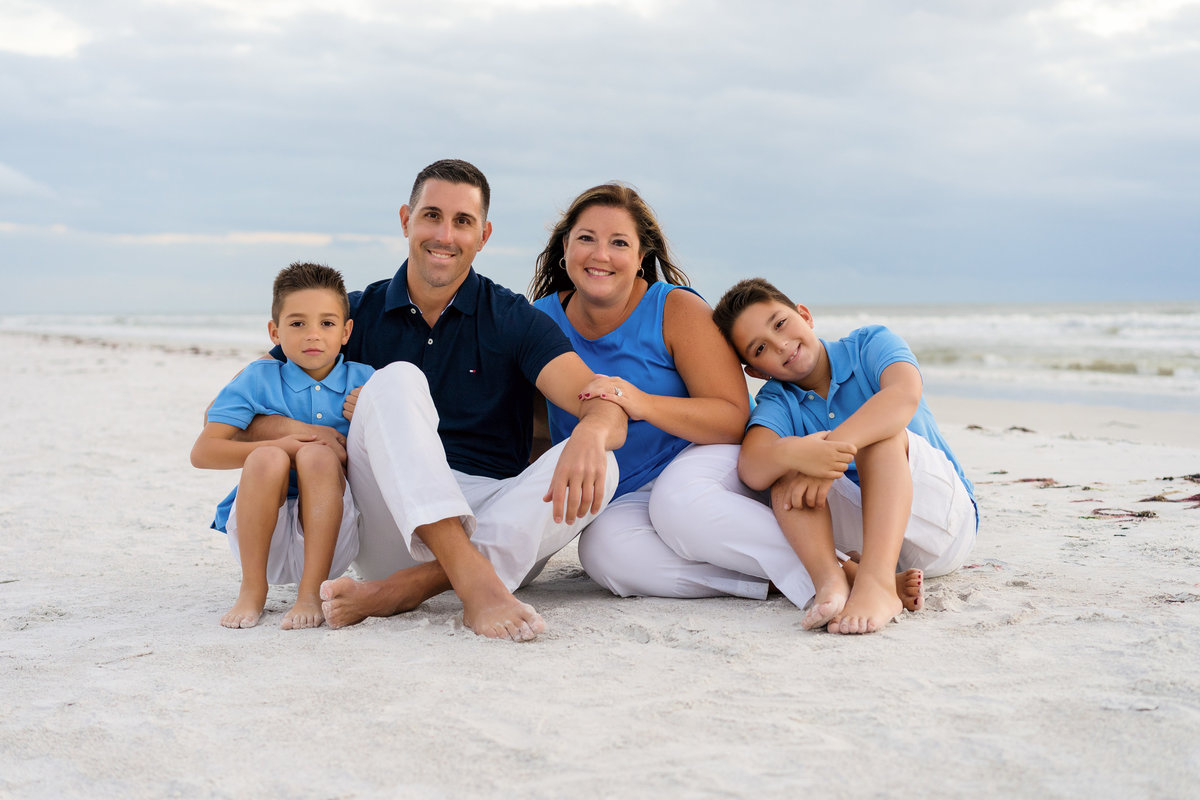 family sitting together for a family photo on Fort Myers Beach Florida