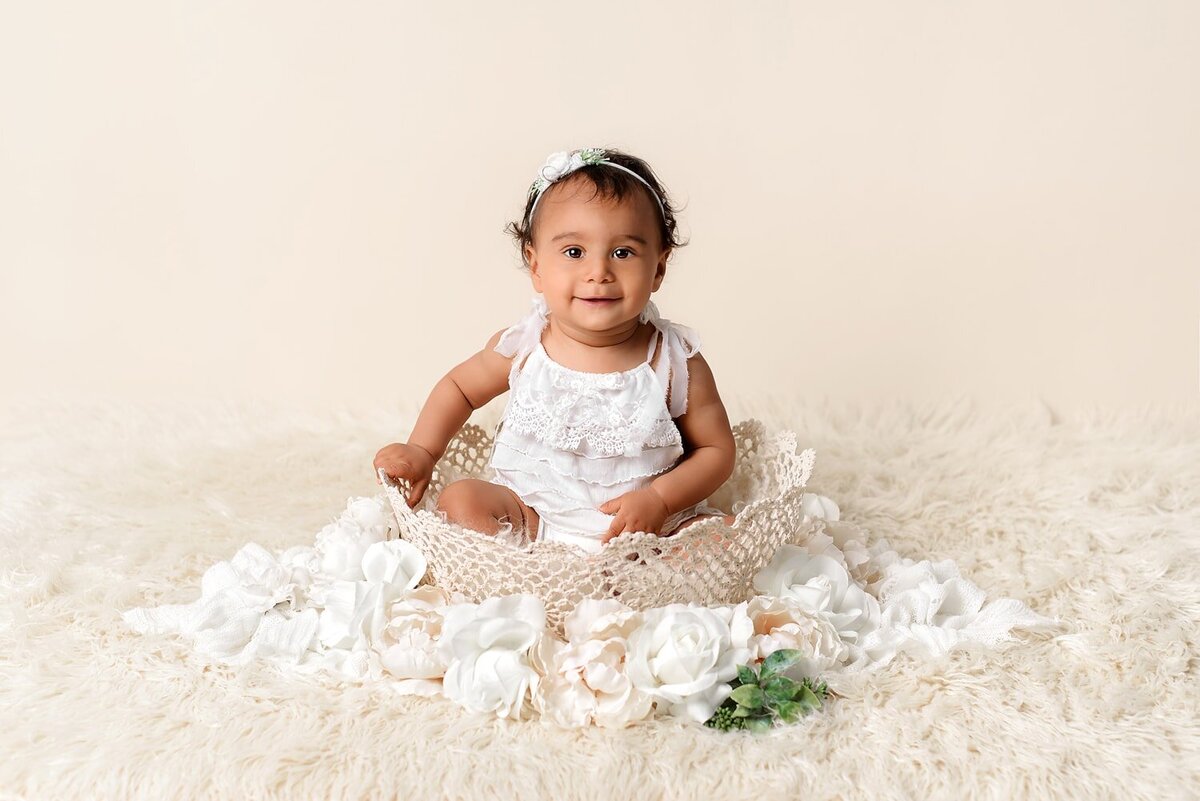 1 year baby girl in white and cream for milestone photo session.
