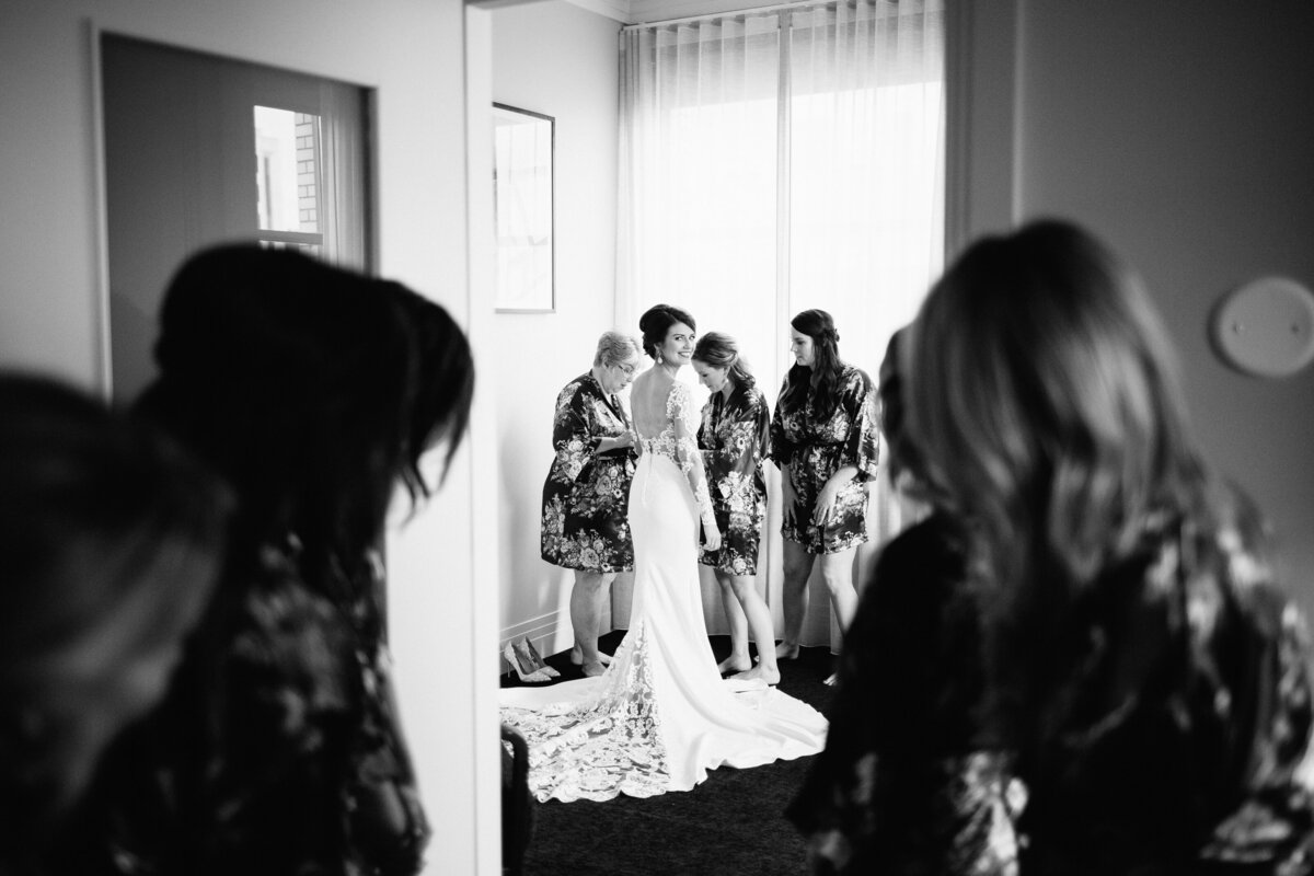 bride is looking back at her bridesmaids in minneapolis