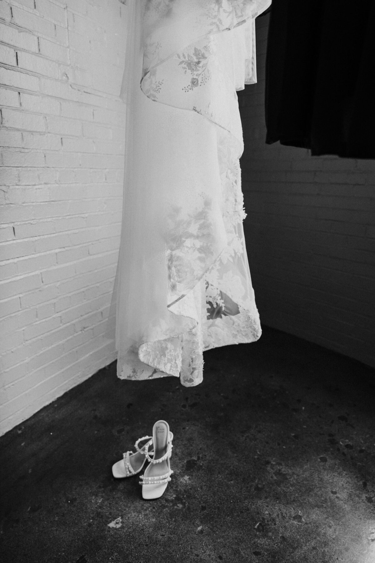 Close up of a wedding dress and shoes.