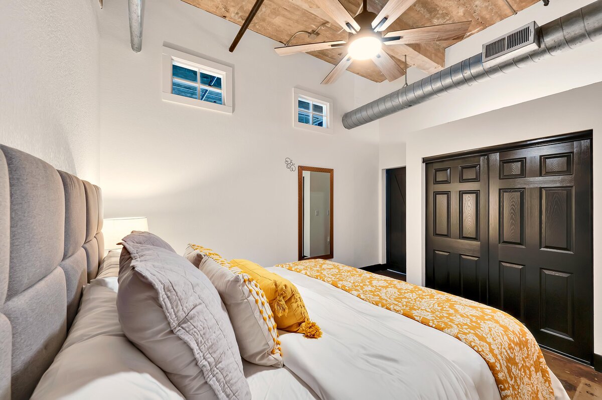 Master bedroom in this one-bedroom, one-bathroom vintage condo that sleeps 4 in the historic Behrens building in the heart of the Magnolia Silo District in downtown Waco, TX.