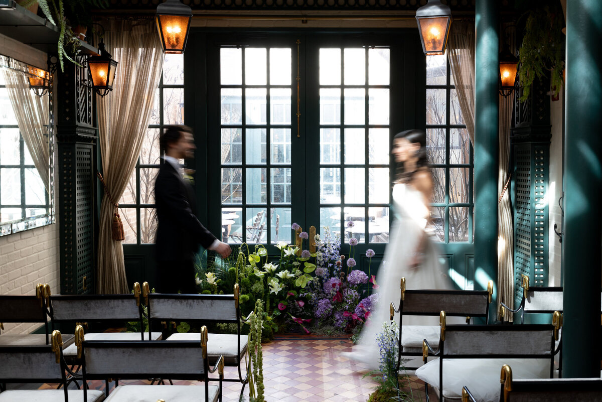 artistic Hotel Chelsea wedding photo of couple walking with motion blur