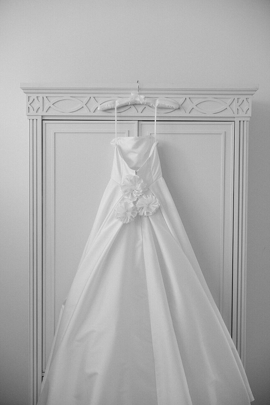 bride's dress hanging on armoire