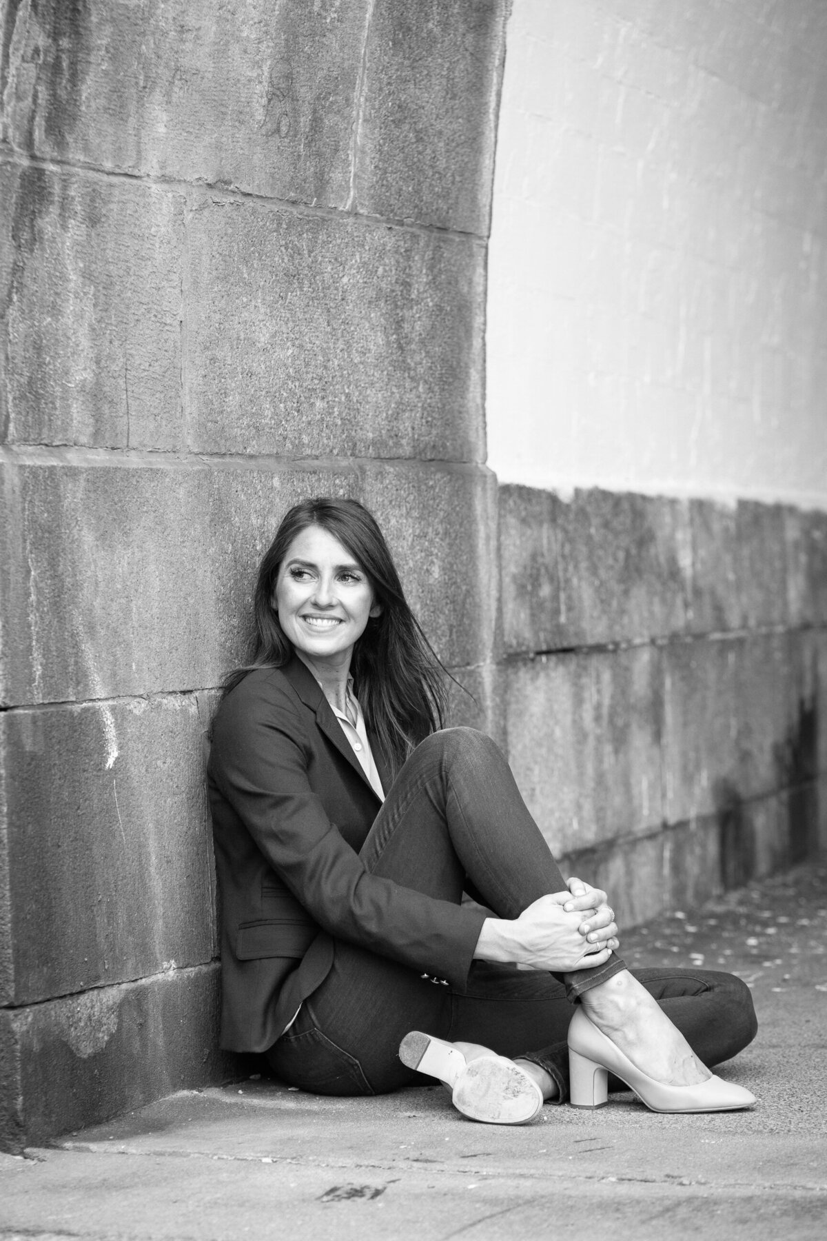 woman sitting agaist a wall