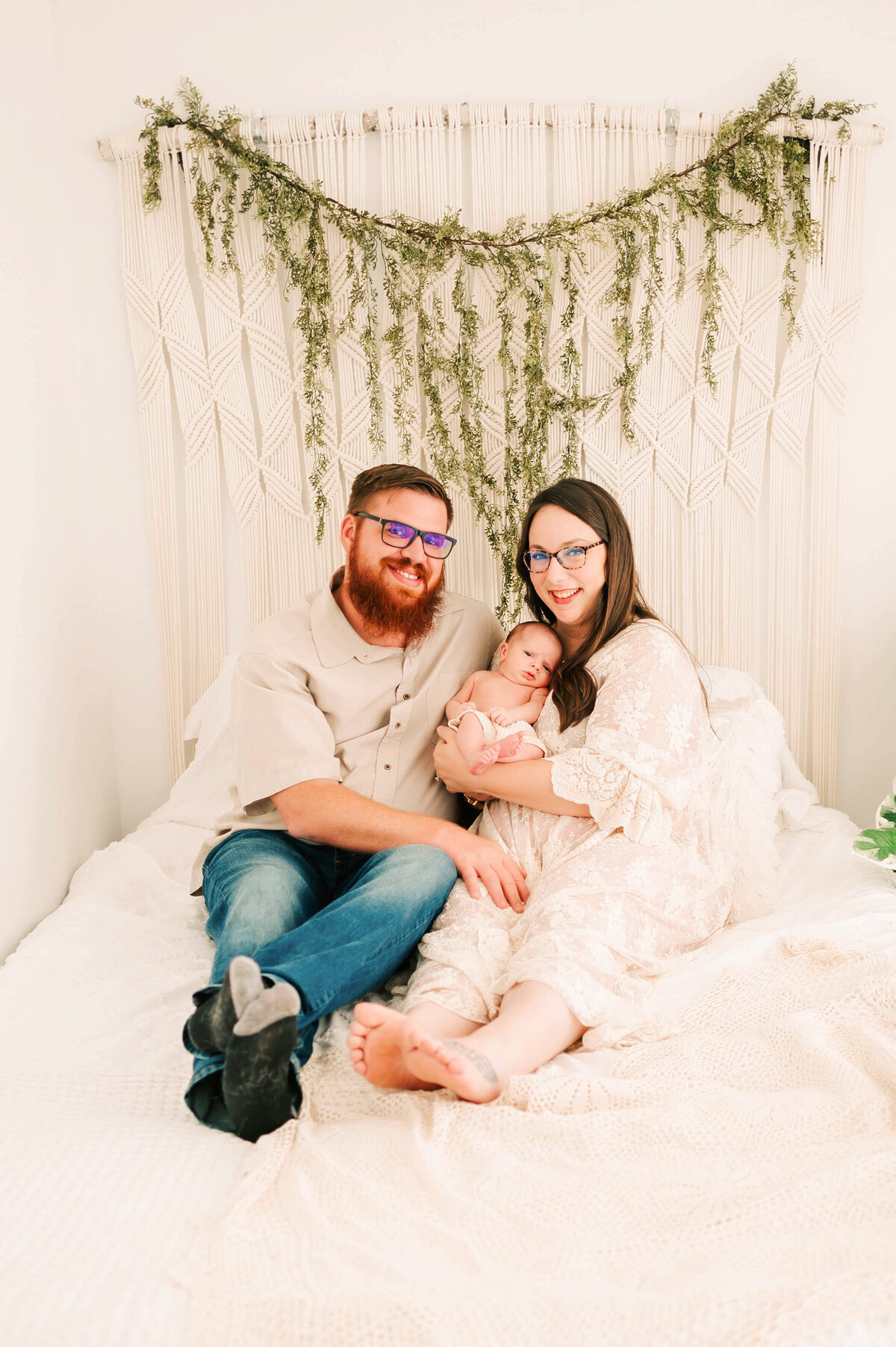 newborn family photo in bed captured by Branson MO newborn photographer Jessica Kennedy of The XO Photography