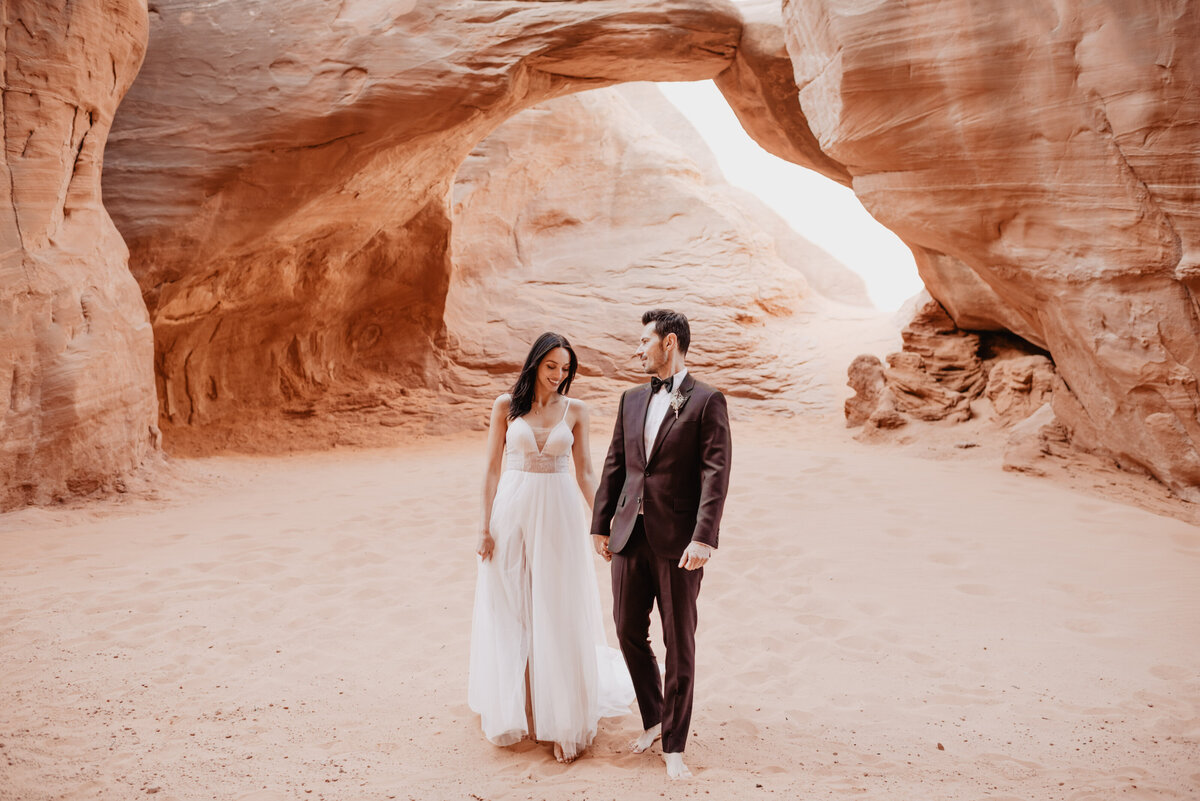 Utah elopement photographer captures couple walking together during bridal portraits