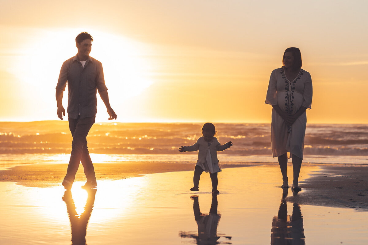 family. waking the beach at sunset