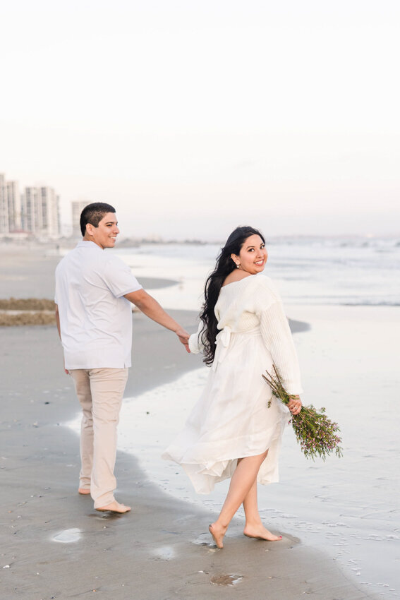 couple-walking-down-Coronado-beach-San-Diego