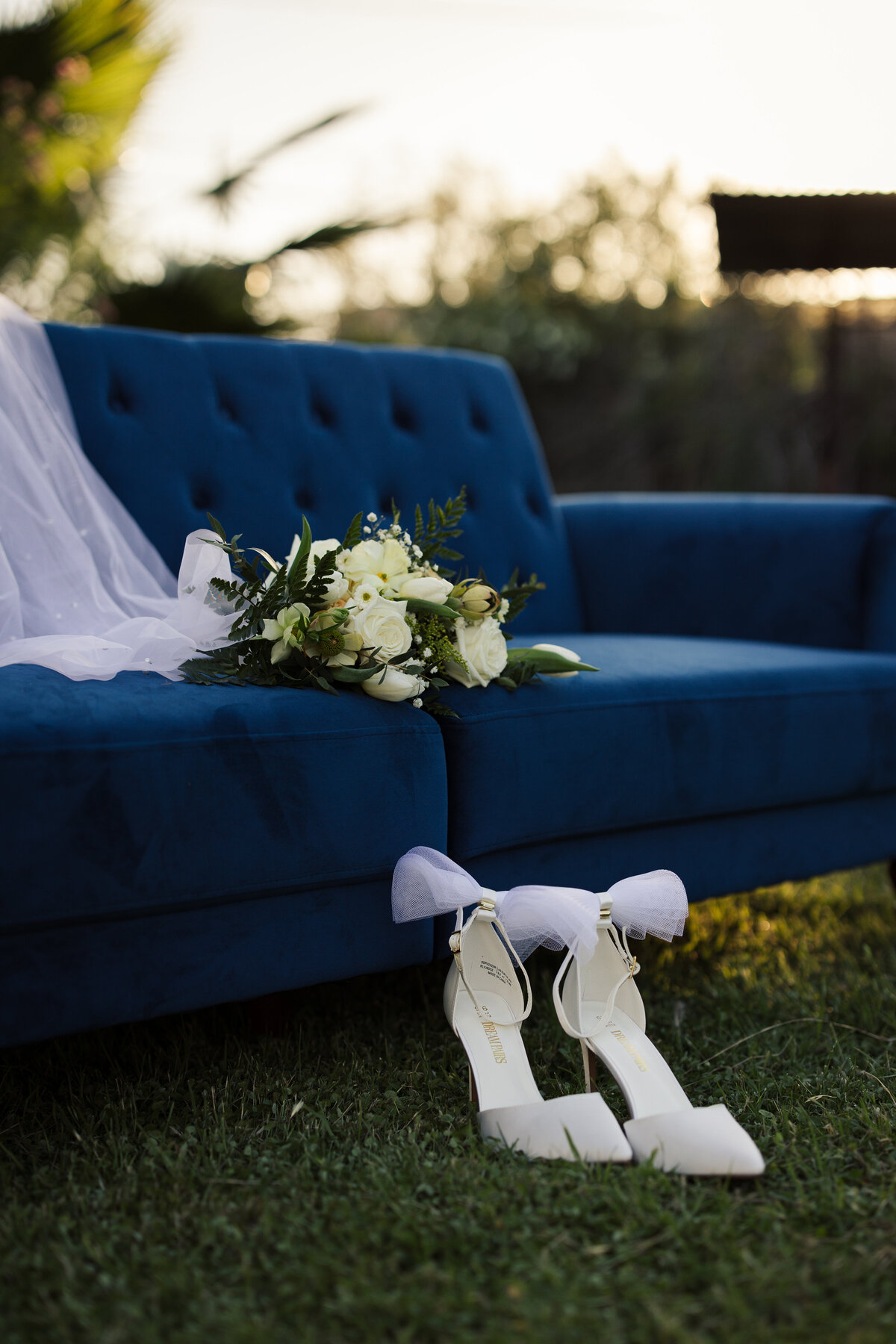 Blue velvet couch with shoes, bridal details image