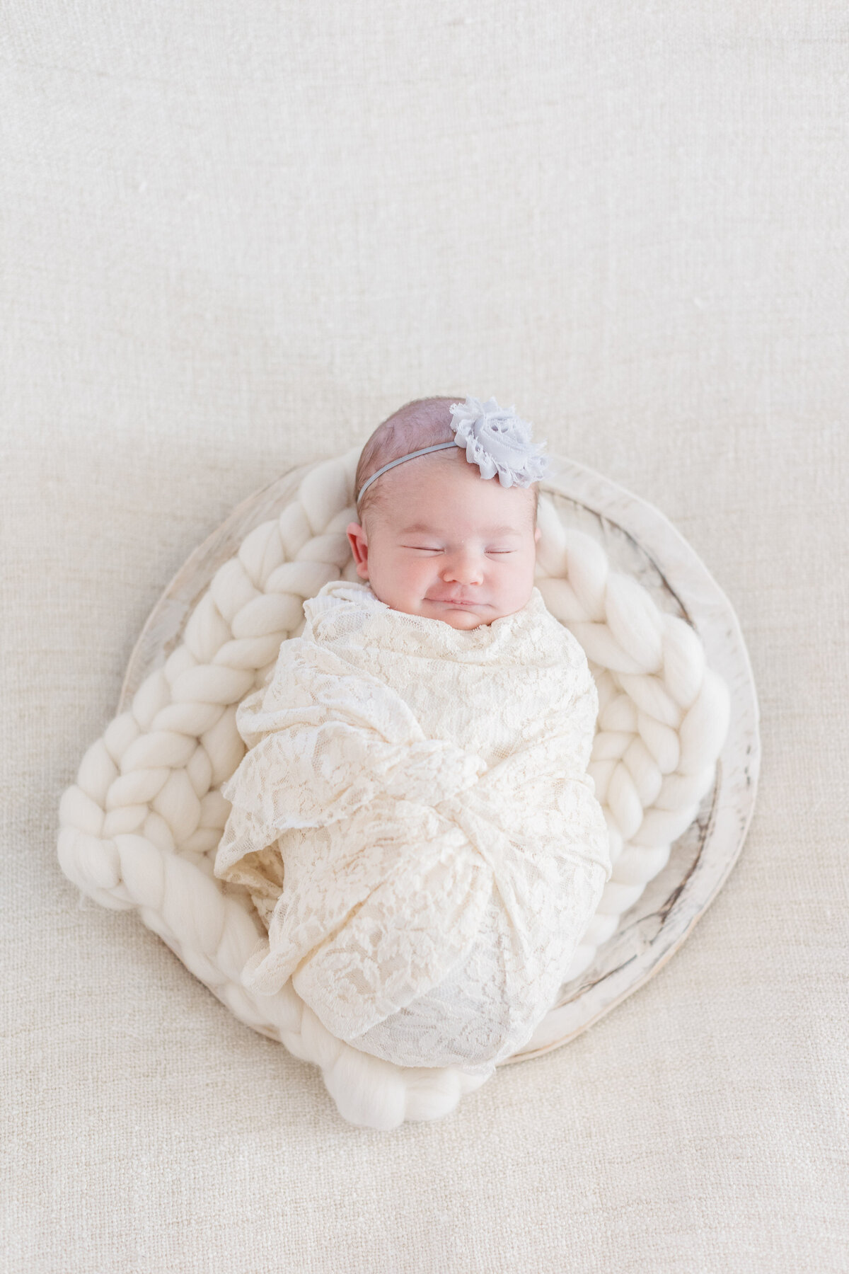 A newborn laying on a fuzzy blanket