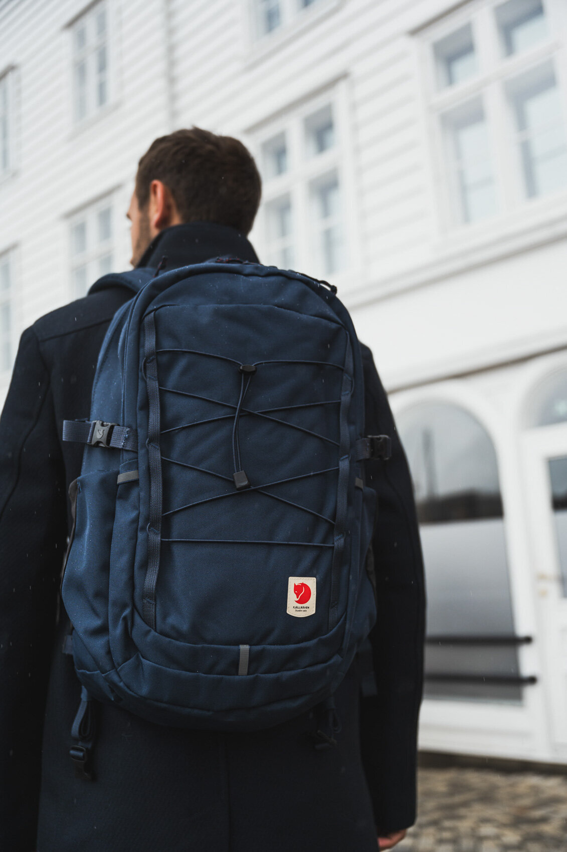 Male model walking through Norway with bagpack Duifhuizen