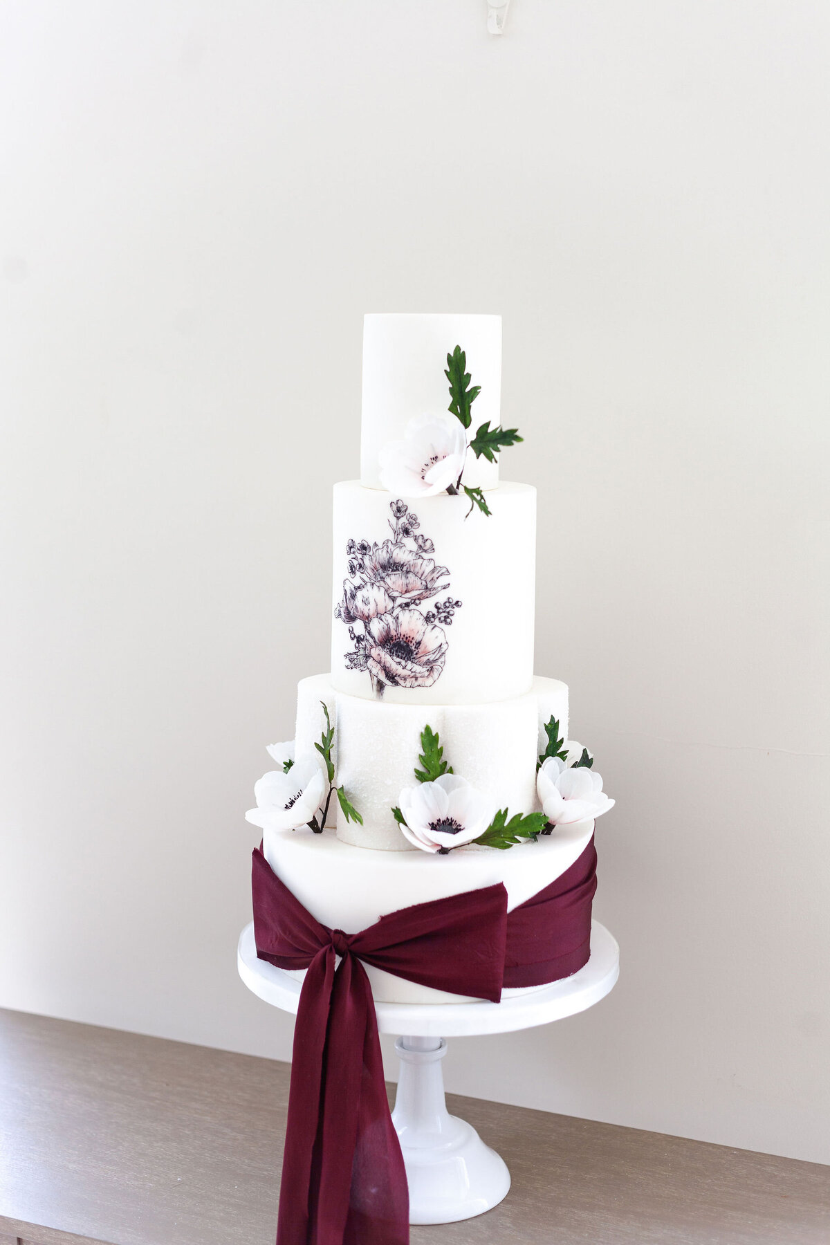 Luxury nature inspired wedding cake designer vanilla Spice Cake Studio Northamptonshire 4 tier white hand painted floral cake with silk ribbon