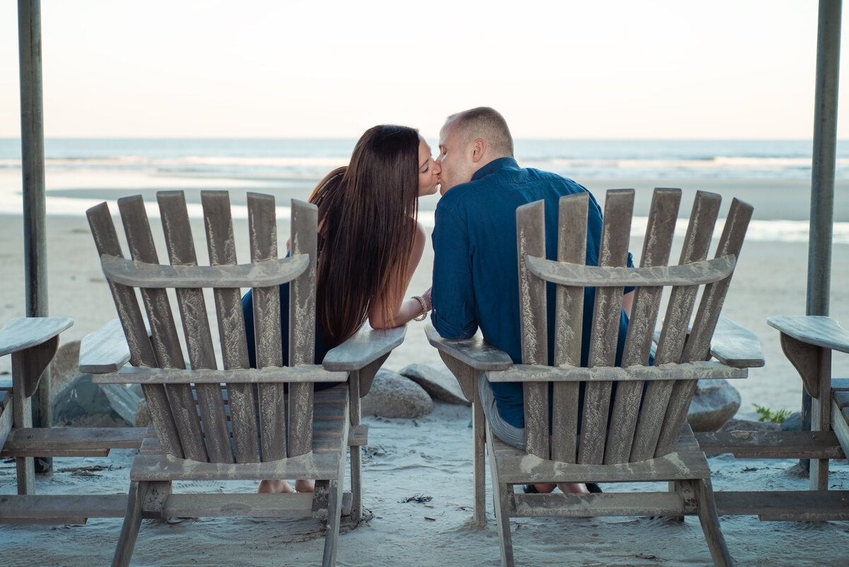 Engaged couple kissing on beach in Ogunquit Maine