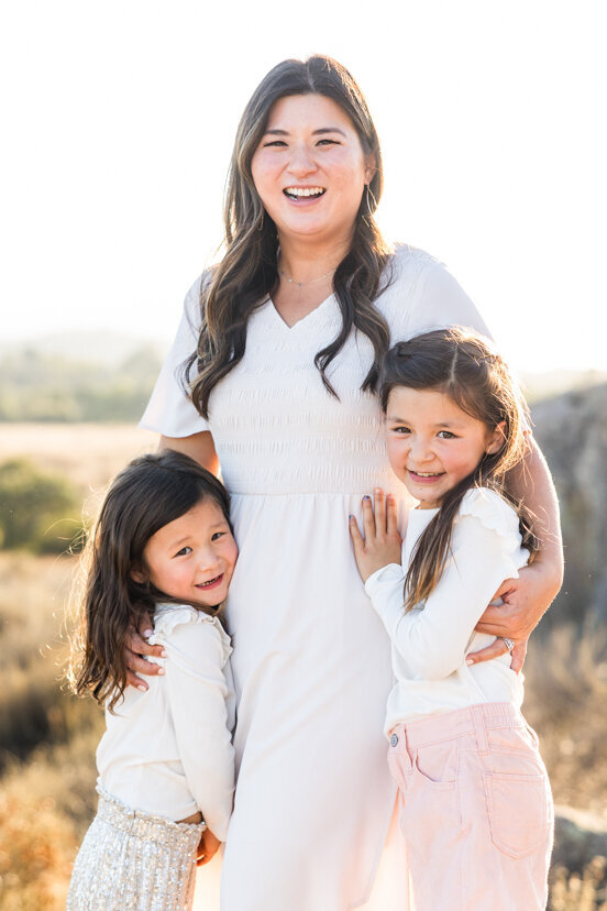 mother-and-daughters-family-of-four-sitting-on-rock-wrights-field-san-diego