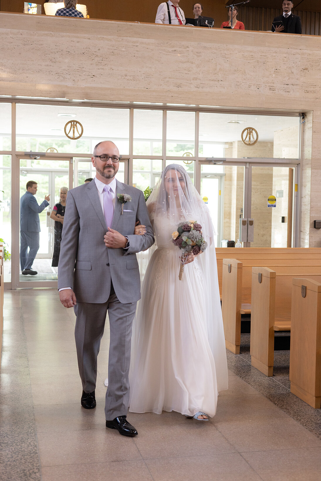 father-walking-daugher-down-the-aisle-at-tlm-wedding