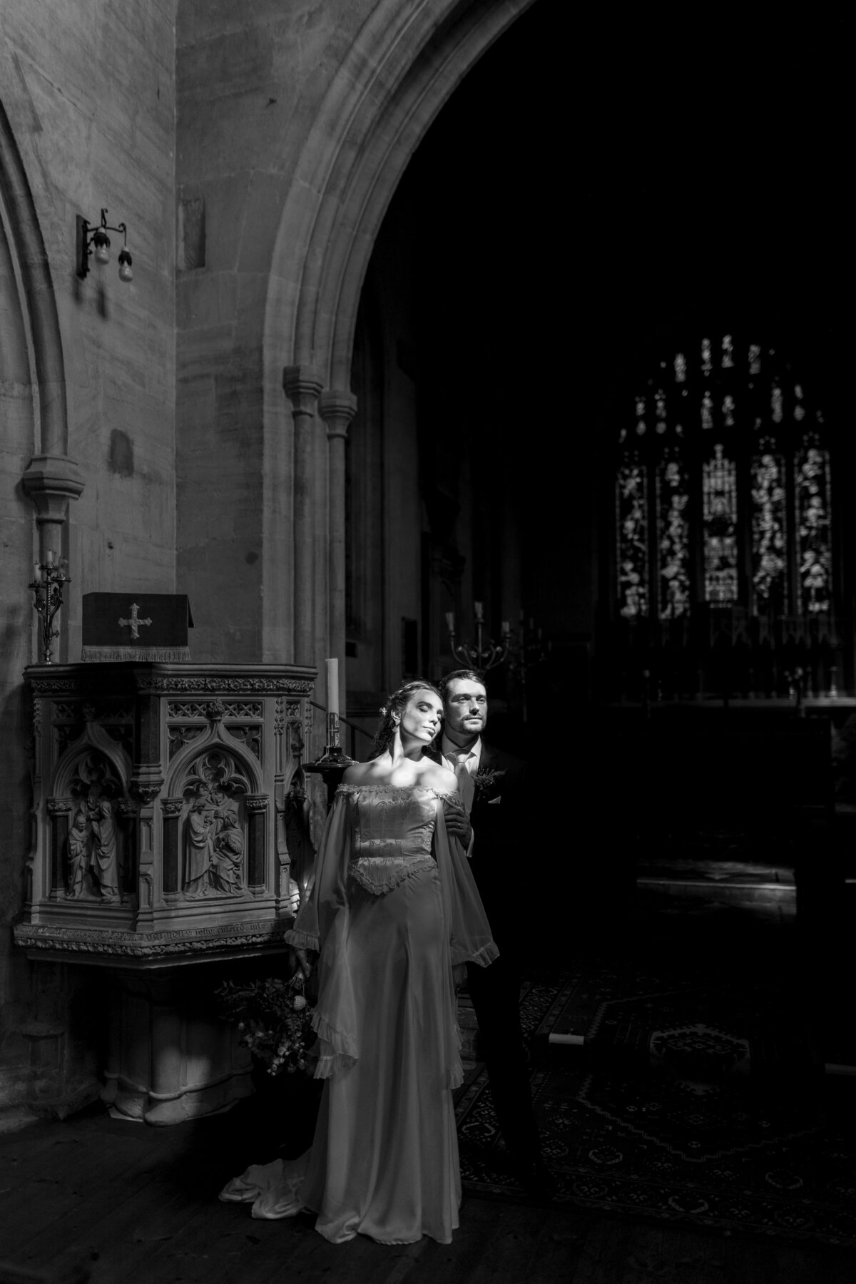 Couple portrait in Wiltshire church from documentary wedding photographers, The Falkenburgs
