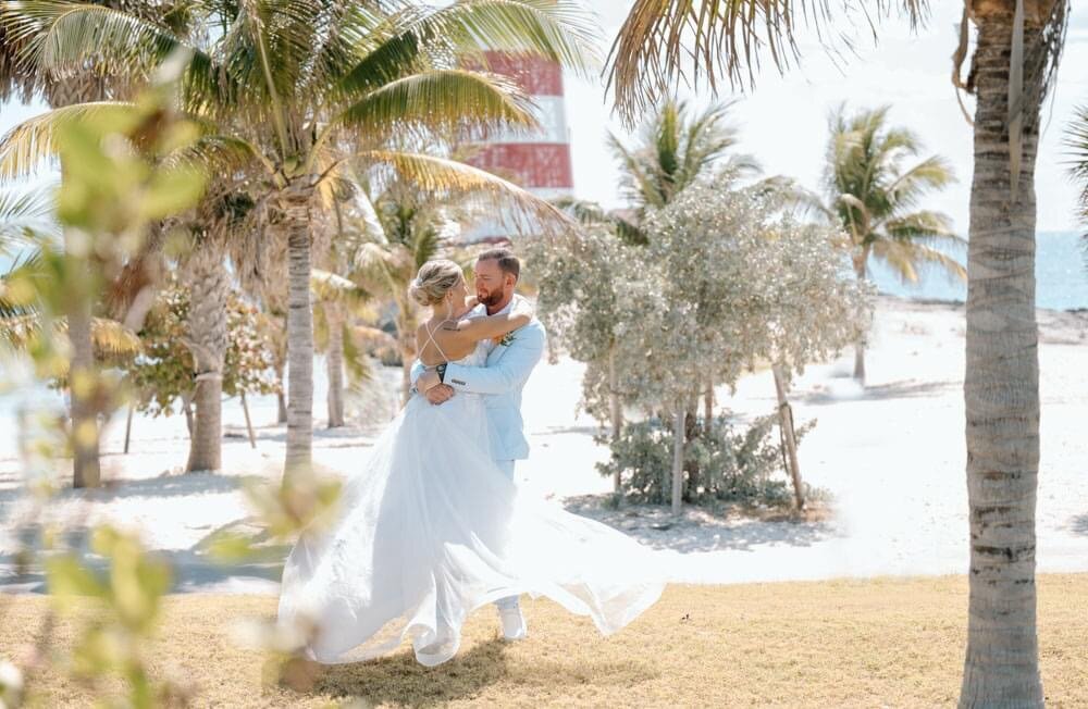 a bride and groom by a lighthouse in the Bahamas