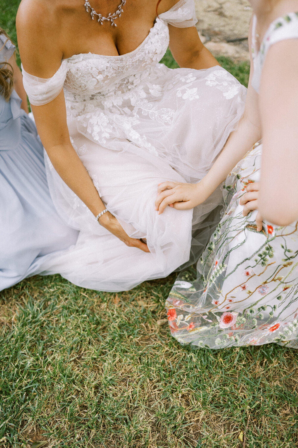bride-laying-in-grass-with-daughters-embroidered-dresses