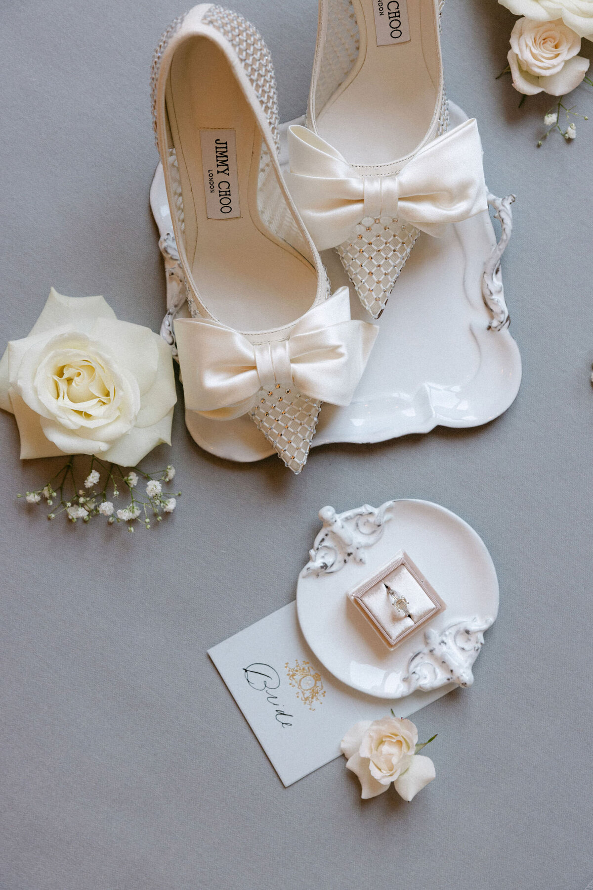Flatlay of the engagement ring and the Jimmy Choo bridal shoes.