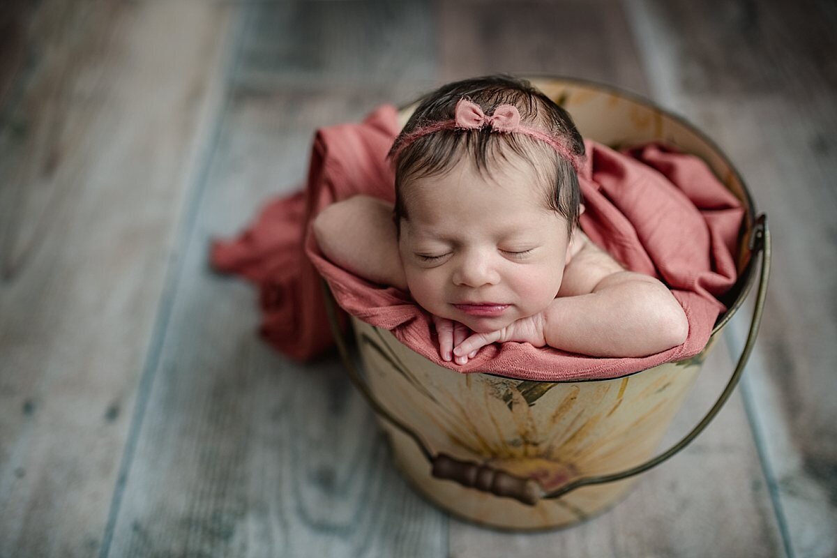 newborn-girl-in-flower-bucket