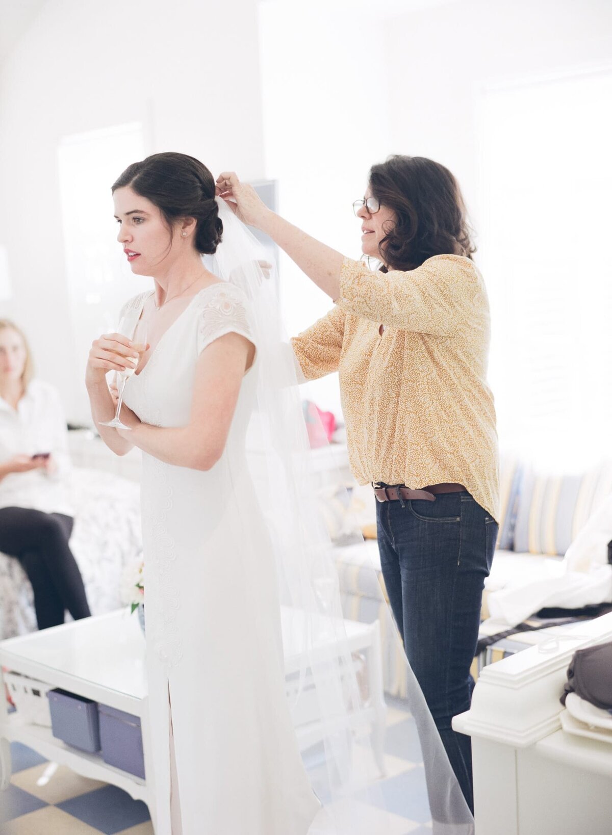 Bridal dress stylist prepares a bride for her big day.