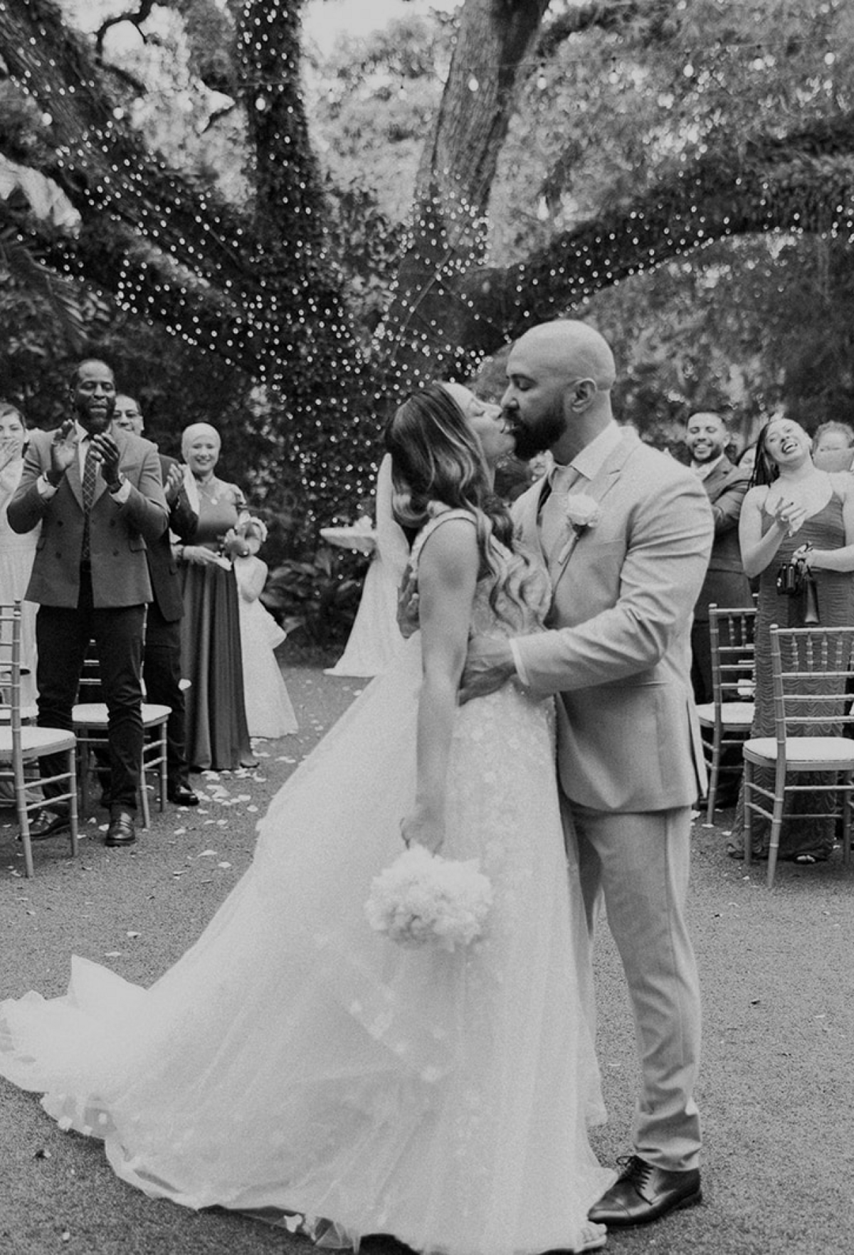 Bride and groom sharing a kiss under twinkling lights at their Miami wedding ceremony, captured by Claudia Amalia, a wedding and lifestyle photographer based in Miami and Florida Keys, South Florida. Destination weddings available. Portfolio highlight.