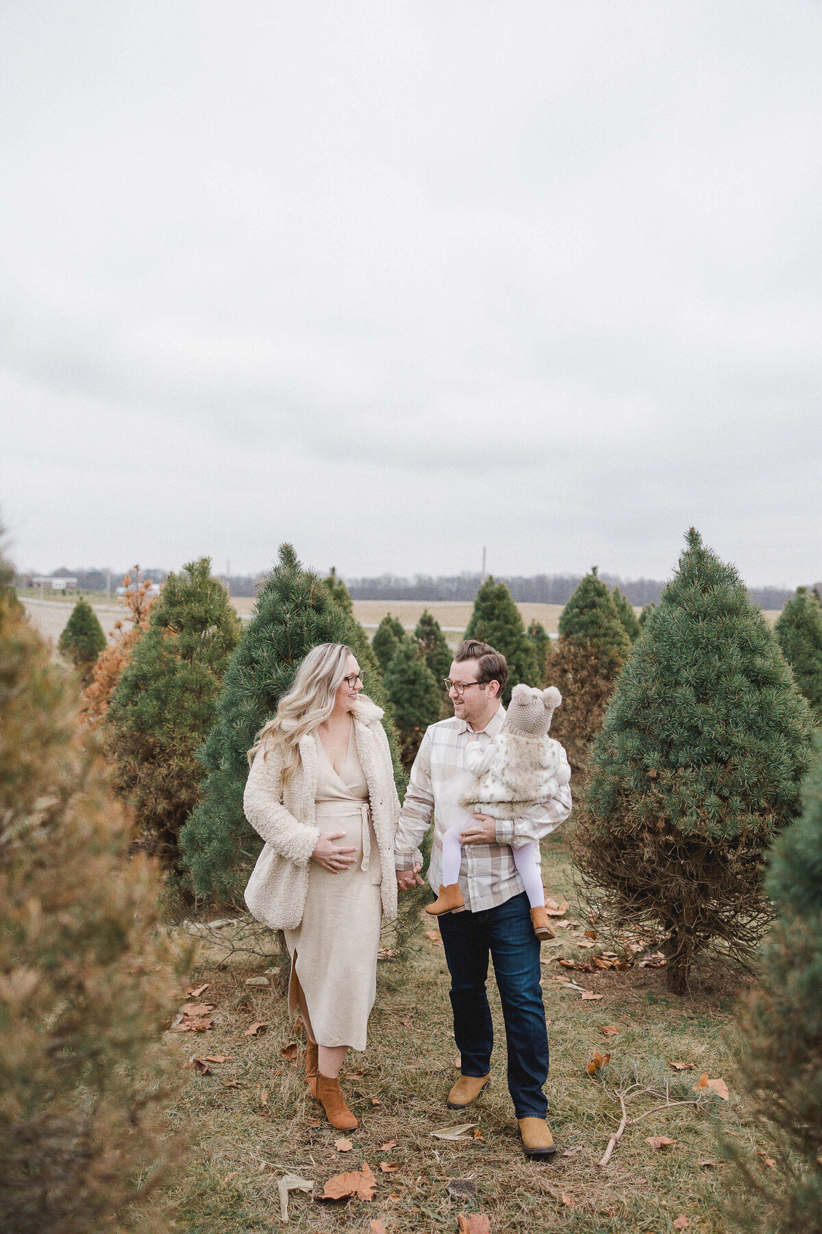 family walking in tree farm