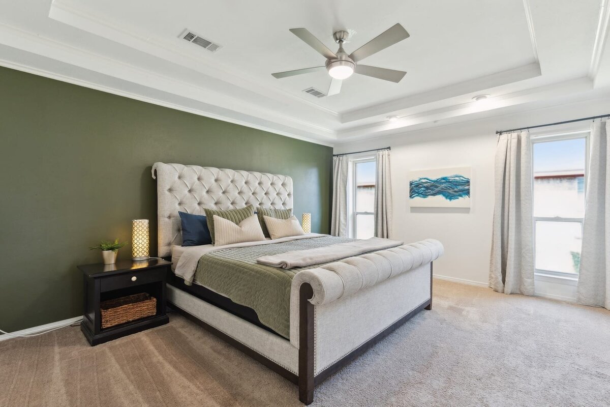 10216_shadow_way_dallas_tx_primary_bedroom_-_green_accent_wall_with_tray_ceiling_and_luxury_bed_-_haven_realty_group